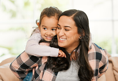 Buy stock photo Shot of a mother and daughter bonding on the sofa at home