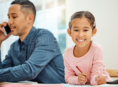 Buy stock photo Cropped portrait of an adorable little girl doing her homework while her dad makes a phonecall in the background