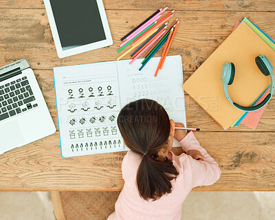 Buy stock photo High angle shot of an unrecognizable little girl doing her homework