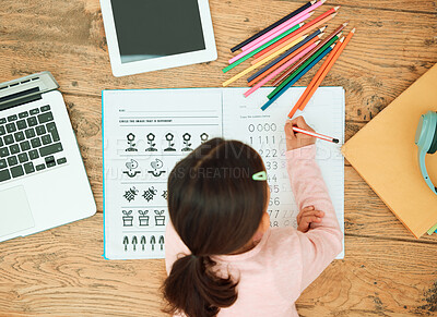 Buy stock photo High angle shot of an unrecognizable little girl doing her homework