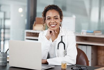 Buy stock photo Cropped portrait of an attractive young female doctor working at her desk in the office