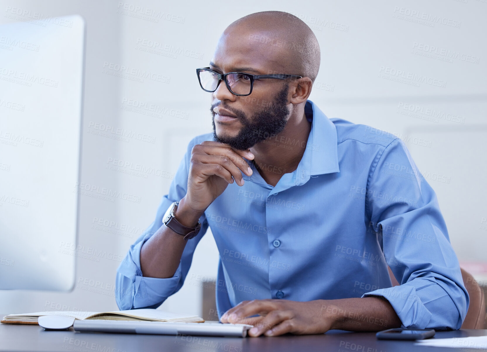 Buy stock photo Black man, office and thinking with computer for online research, information and ideas in start up company. Project manager, notebook and browsing or reading on internet website for business growth