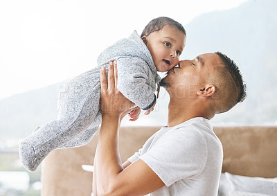 Buy stock photo Father, baby and lifting in home for kiss, childcare for development, support and bonding. Toddler, man and playful in parenting, growth and love with happiness, joy and family as infant in morning