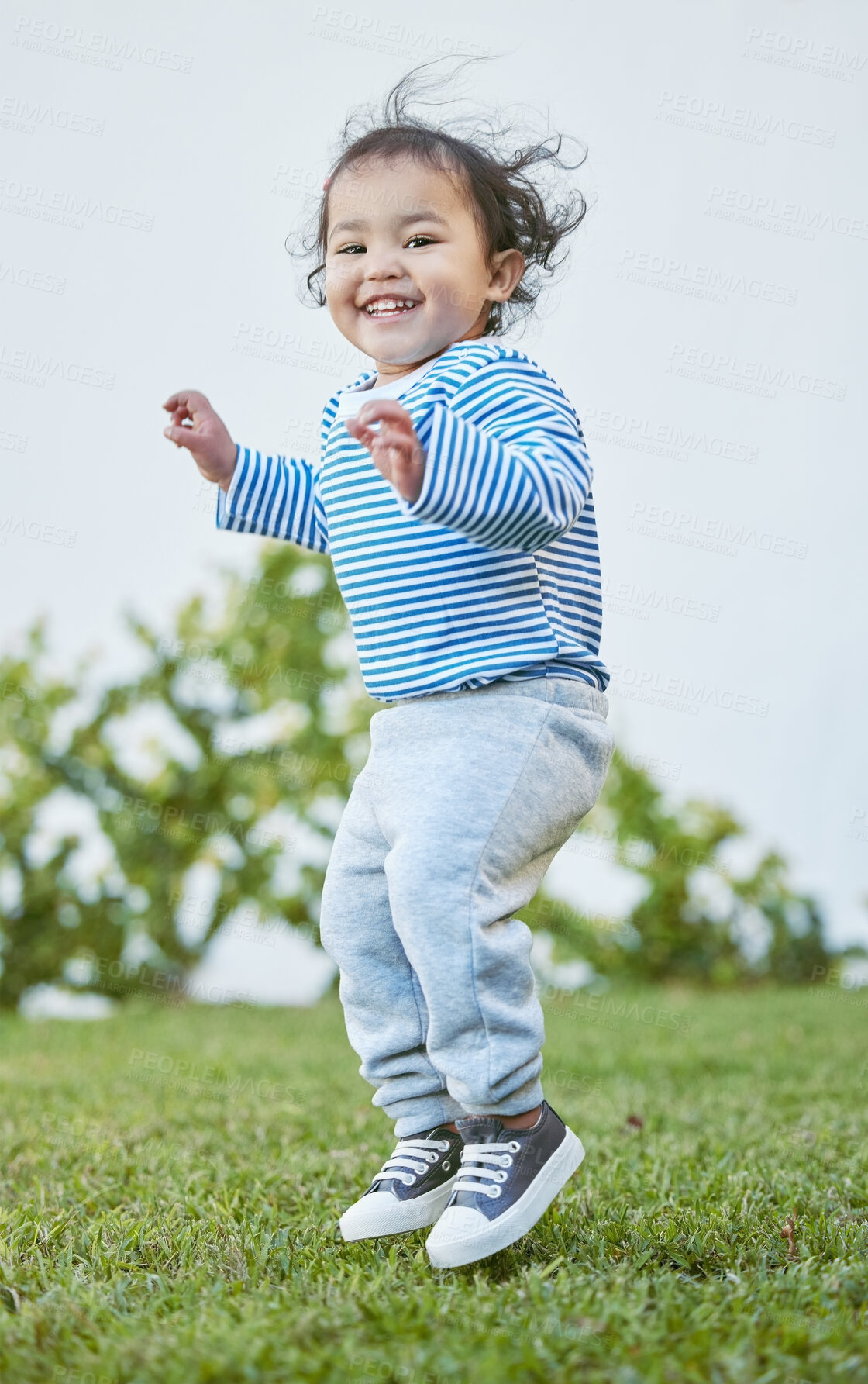 Buy stock photo Backyard, portrait and toddler with jump for playing, cheerful and imagination with smile for creativity. Outdoor, child and excited with energy for air games, fun and carefree with entertainment