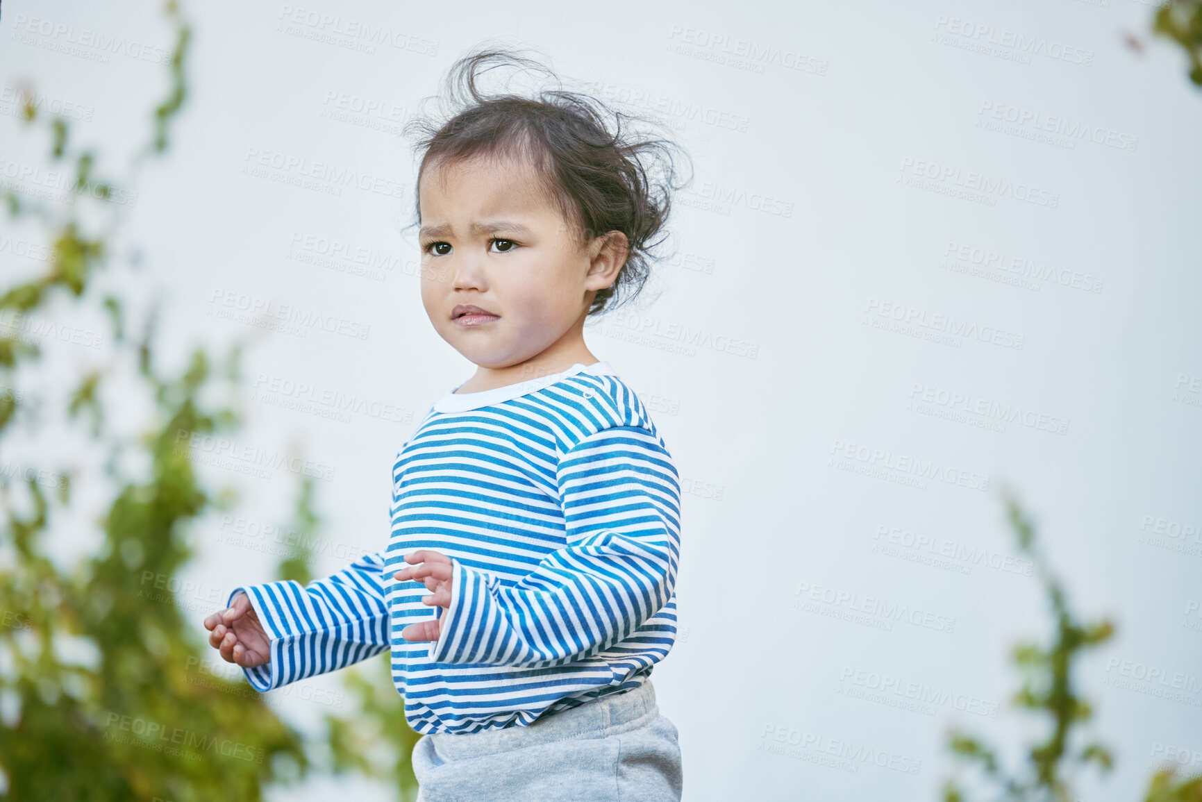 Buy stock photo Outdoor, boy and baby in backyard, sad and upset with breeze, calm and peaceful. House, outside and infant in garden, facial expression and emotions with reaction, childhood and tantrum with wind