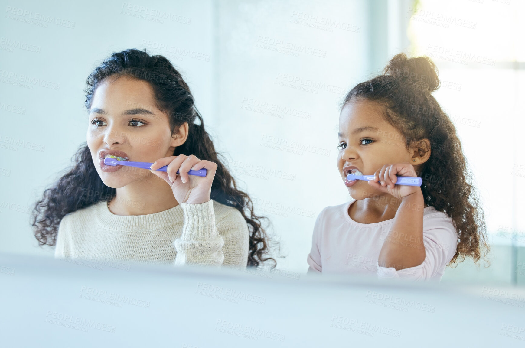 Buy stock photo Mom, girl and brushing teeth in reflection or bathroom for dental care, oral health and teaching for development. Mother, child and together in family home for morning routine, hygiene and wellness. 