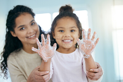 Buy stock photo Soap, cleaning hands and family with child in bathroom for learning, healthy hygiene and routine at home. Portrait, mom and girl washing with foam for safety of bacteria, dirt or germs on skincare