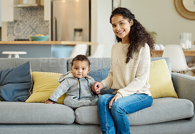 Buy stock photo Shot of a young mother bonding with her baby boy on the sofa at home