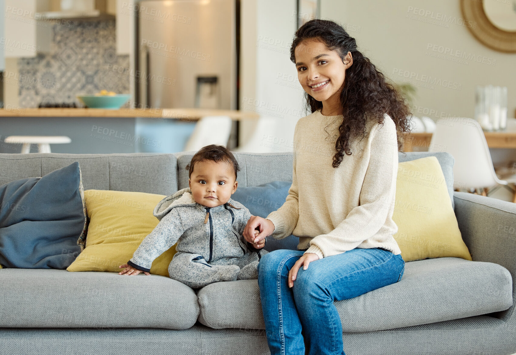 Buy stock photo Shot of a young mother bonding with her baby boy on the sofa at home