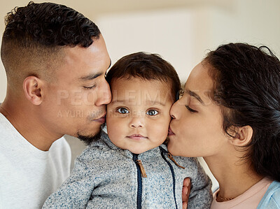 Buy stock photo Shot of a young family bonding with their baby boy at home