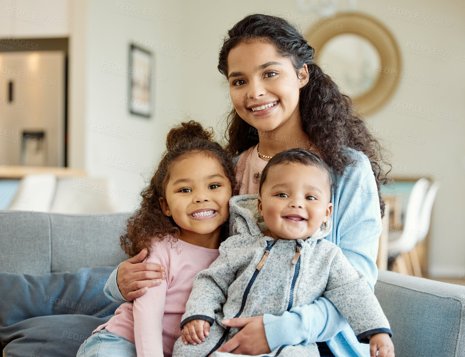 Buy stock photo Shot of a young mother bonding with her kids on the sofa at home