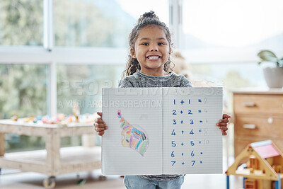 Buy stock photo Shot of an adorable little girl showing off a book with her homework