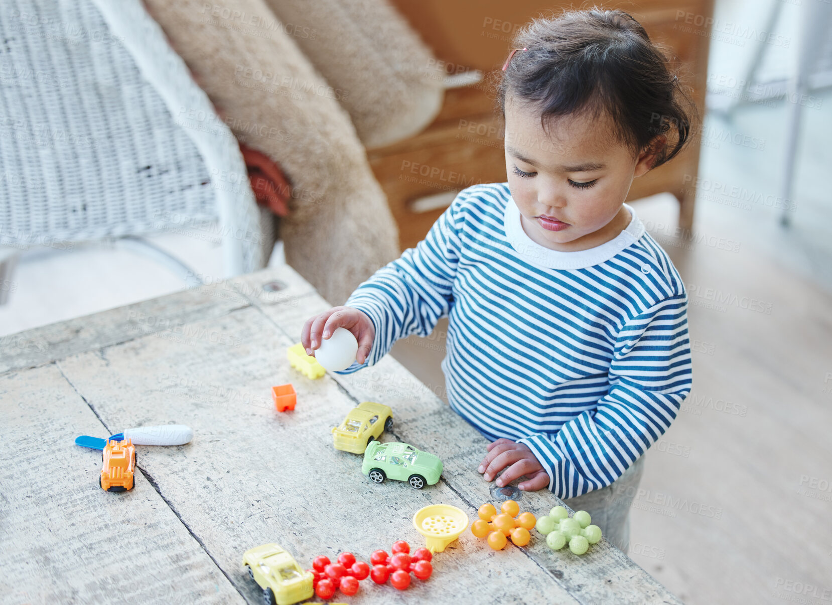 Buy stock photo Toddler, development and playing with toys in home for childhood, boy and learning with plastic cars. Child, growth and childhood games for creativity, playful and preschool fun on wooden table