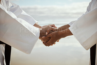 Buy stock photo Closeup shot of two unrecognizable martial artists practicing karate on the beach
