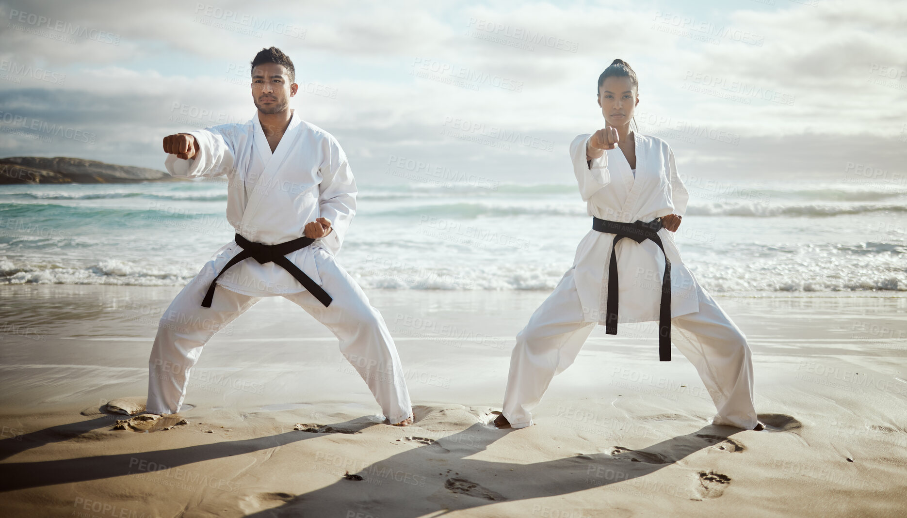 Buy stock photo Ocean, karate and people training for fitness, workout and fight with master at lesson. Warrior, martial arts and team at beach for exercise, taekwondo and performance outdoor with student learning