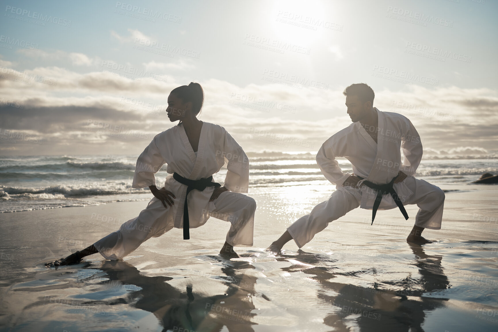 Buy stock photo Karate team, people and training at beach for fighting competition, practice and discipline with fitness. Martial arts, master and teaching student at sunrise with exercise, workout and self defense