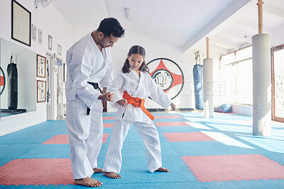Buy stock photo Shot of a young man and cute little girl practicing karate in a studio