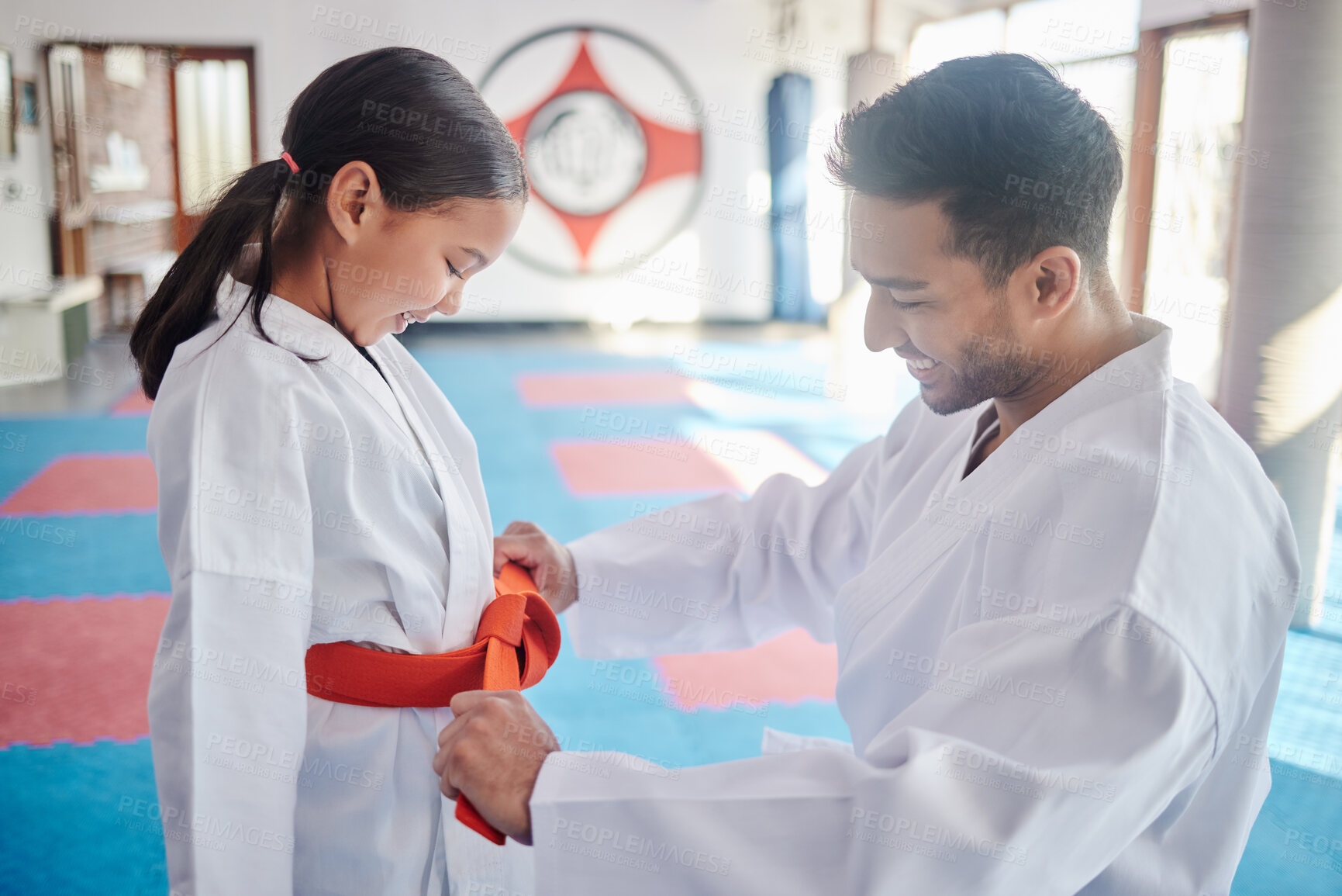 Buy stock photo Martial arts, karate and achievement in studio for fitness, help and respect with orange belt. Sensei, student and celebration as people for self defense class, gratitude and discipline with support