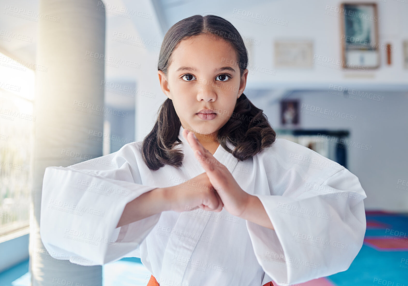 Buy stock photo Portrait, girl or child with martial arts for fitness, strength development and energy for training. Class, student or hand gesture in studio for karate, kung fu or defense skills with fight exercise