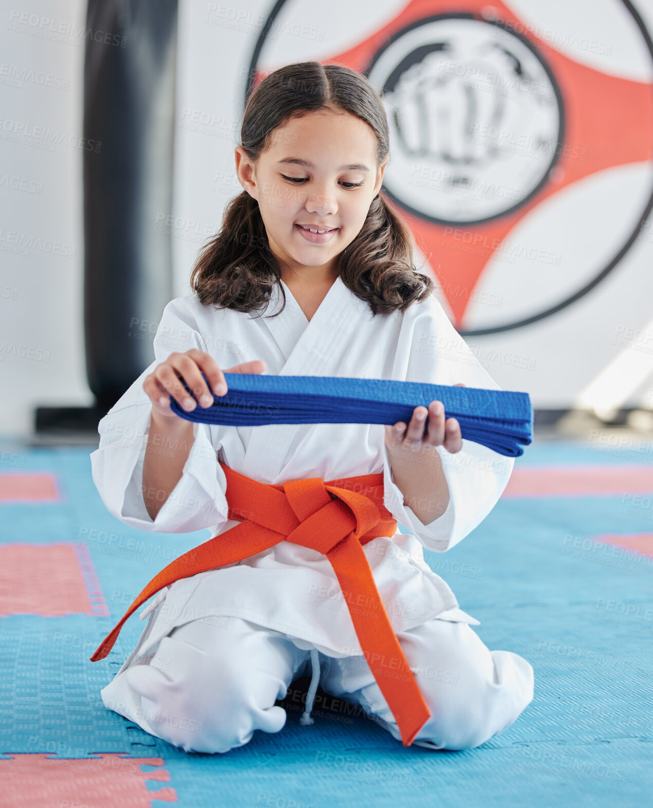 Buy stock photo Shot of a cute little girl practicing karate in a studio