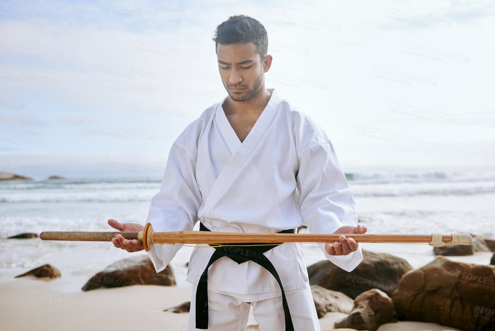 Buy stock photo Asian man, karate and beach with wooden sword for martial arts, training or self defense in nature. Young male person, warrior or samurai with katana, weapon or uniform on ocean coast for taekwondo