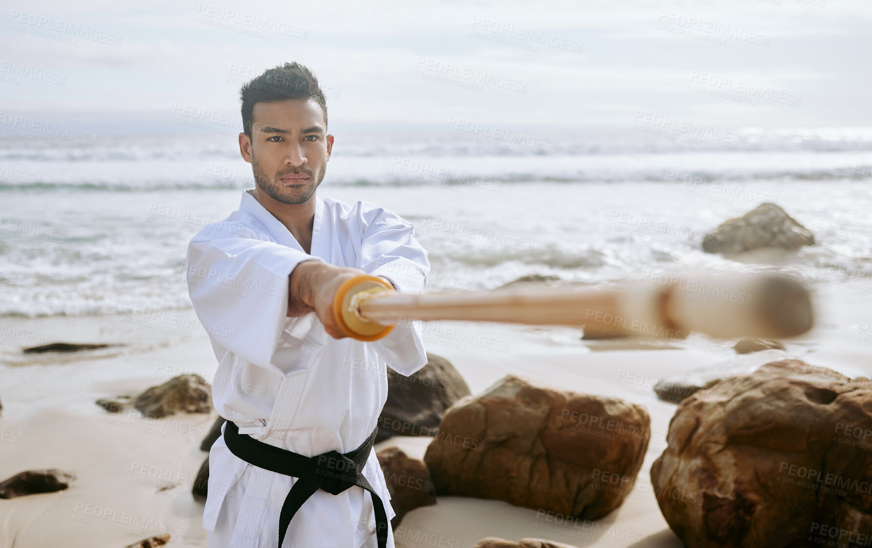 Buy stock photo Karate, beach and man with katana for training, practice and learning aikido, taekwondo and jiujitsu. Sports, nature and person with bokken by ocean for fitness, exercise and workout for martial arts