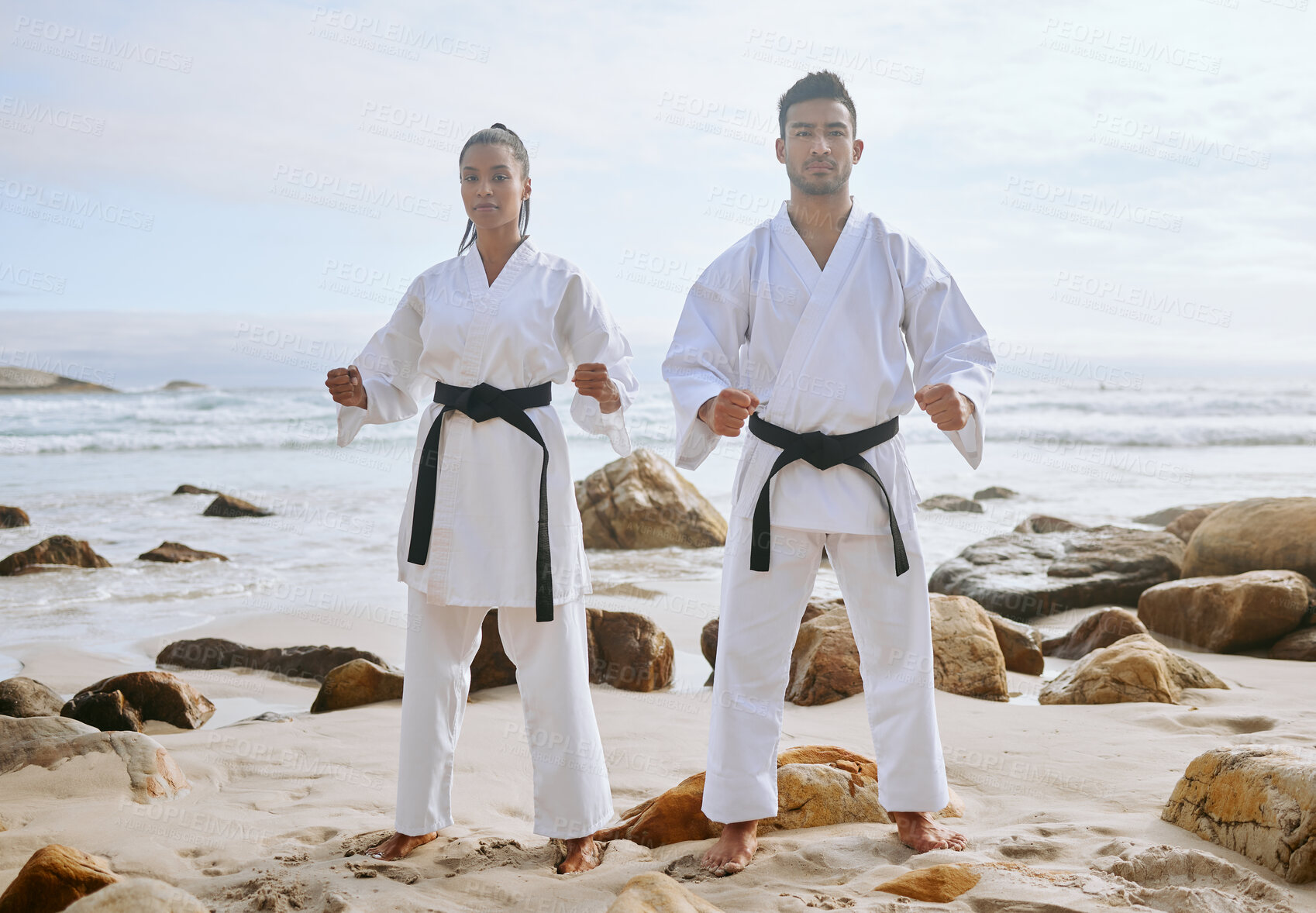 Buy stock photo Karate, martial arts and people on beach for training, practice and learning aikido, taekwondo and jiujitsu. Sports, nature and man and woman by ocean for fitness, exercise and workout for tai chi