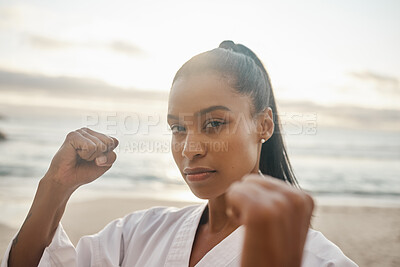 Buy stock photo Portrait of a young martial artist practising karate on the beach