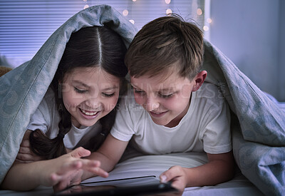 Buy stock photo Shot of two little siblings using a digital tablet together at home