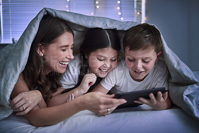 Buy stock photo Shot of two little siblings and their mother using a digital tablet together at home