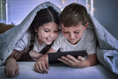 Buy stock photo Shot of two little siblings using a digital tablet together at home