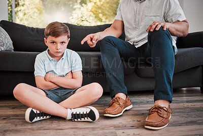 Buy stock photo Shot of a father losing his patience with his son at home