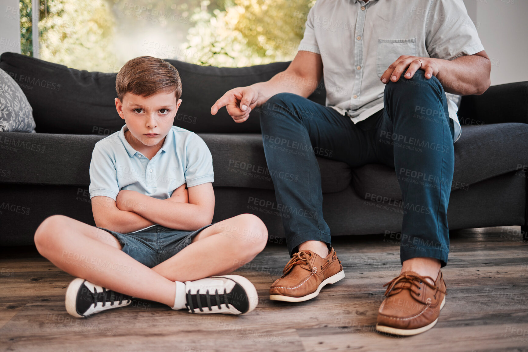 Buy stock photo Shot of a father losing his patience with his son at home