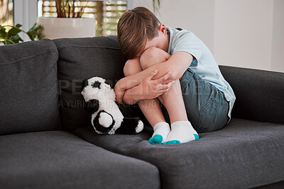 Buy stock photo Shot of a little boy comforting himself on a sofa at home