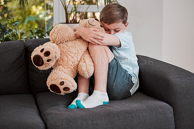 Buy stock photo Shot of a little boy comforting himself on a sofa at home