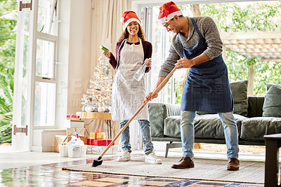 Buy stock photo Shot of a young couple cleaning the lounge at home