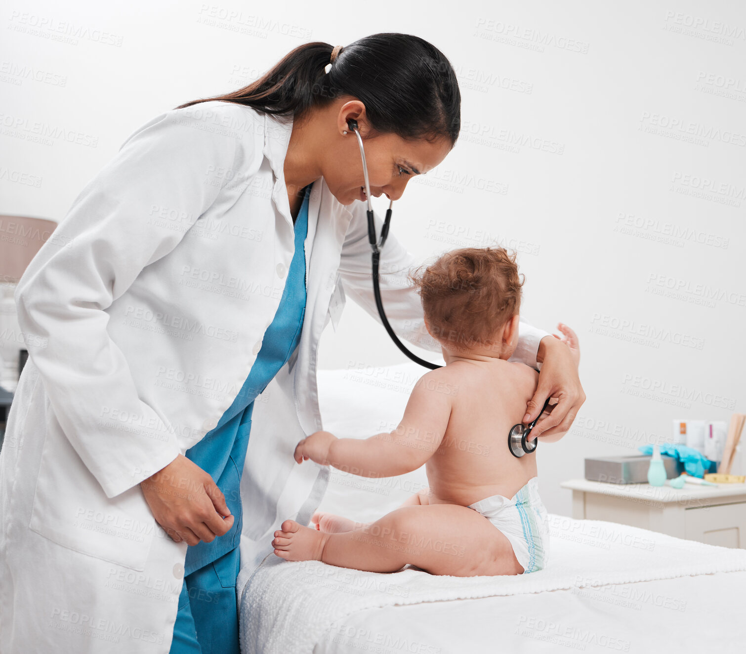 Buy stock photo Shot of a paediatrician examining a baby in a clinic