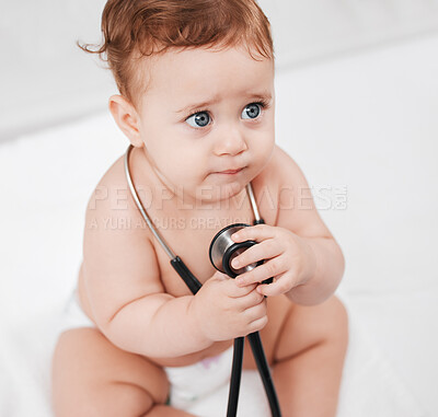 Buy stock photo Shot of an adorable little baby boy hold a stethoscope in a clinic during his checkup