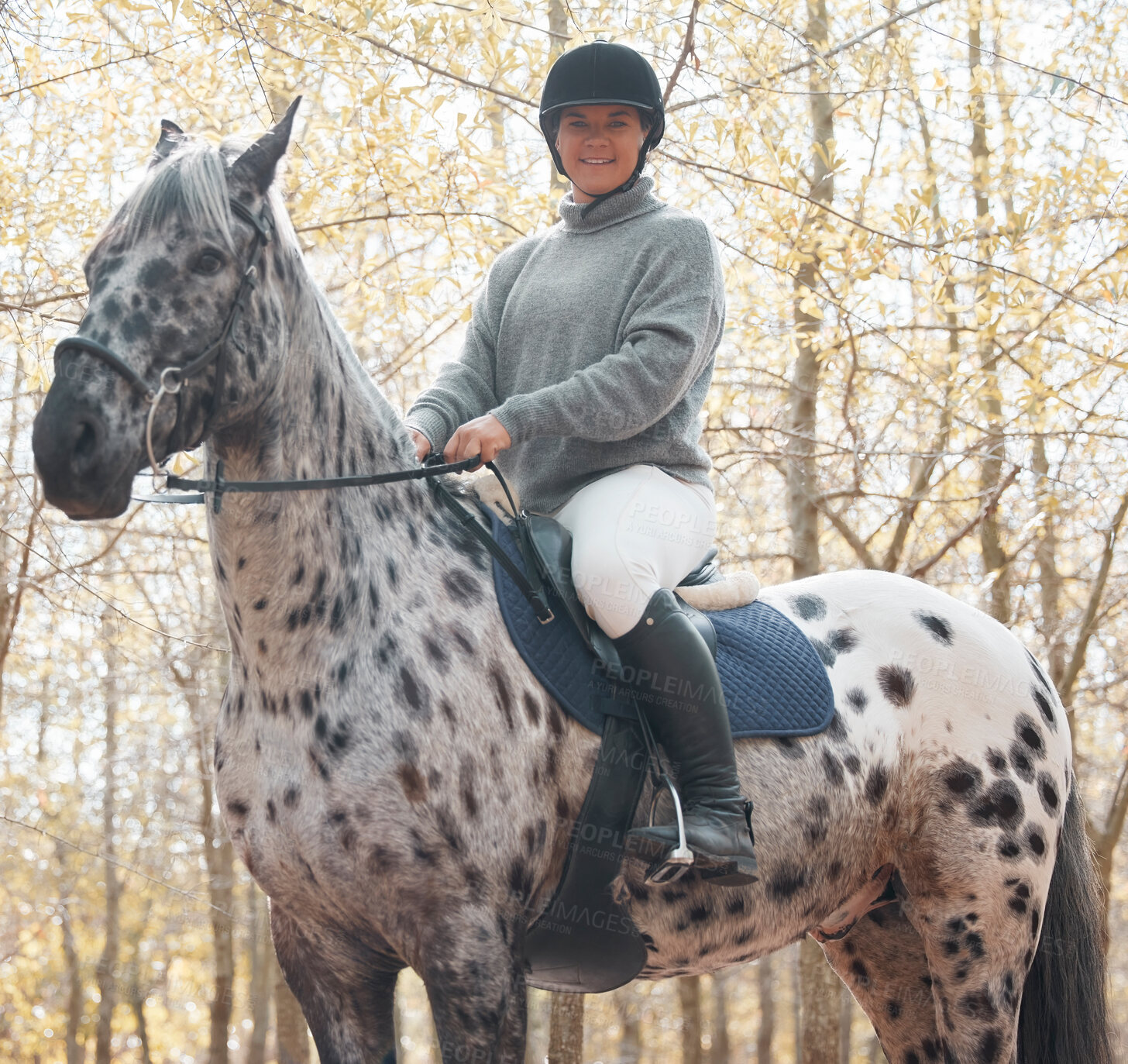 Buy stock photo Shot of an attractive young woman riding with her horse outside