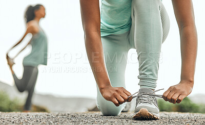 Buy stock photo Shot of an unrecognizable person tying their shoelaces before a run