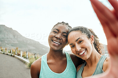 Buy stock photo Shot of two young women taking a selfie while exercising in nature