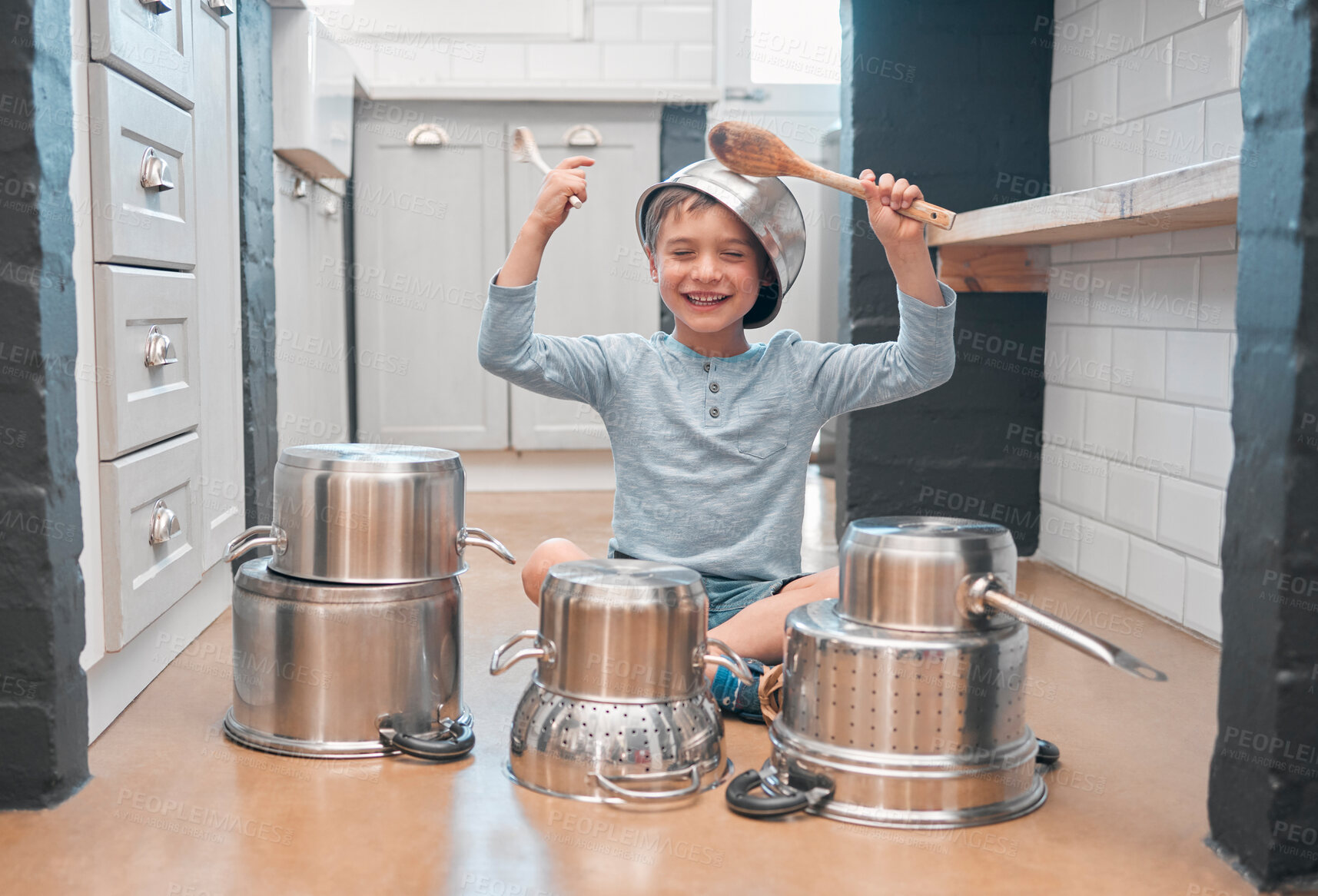 Buy stock photo Shot of an adorable little boy playing with pots in the kitchen