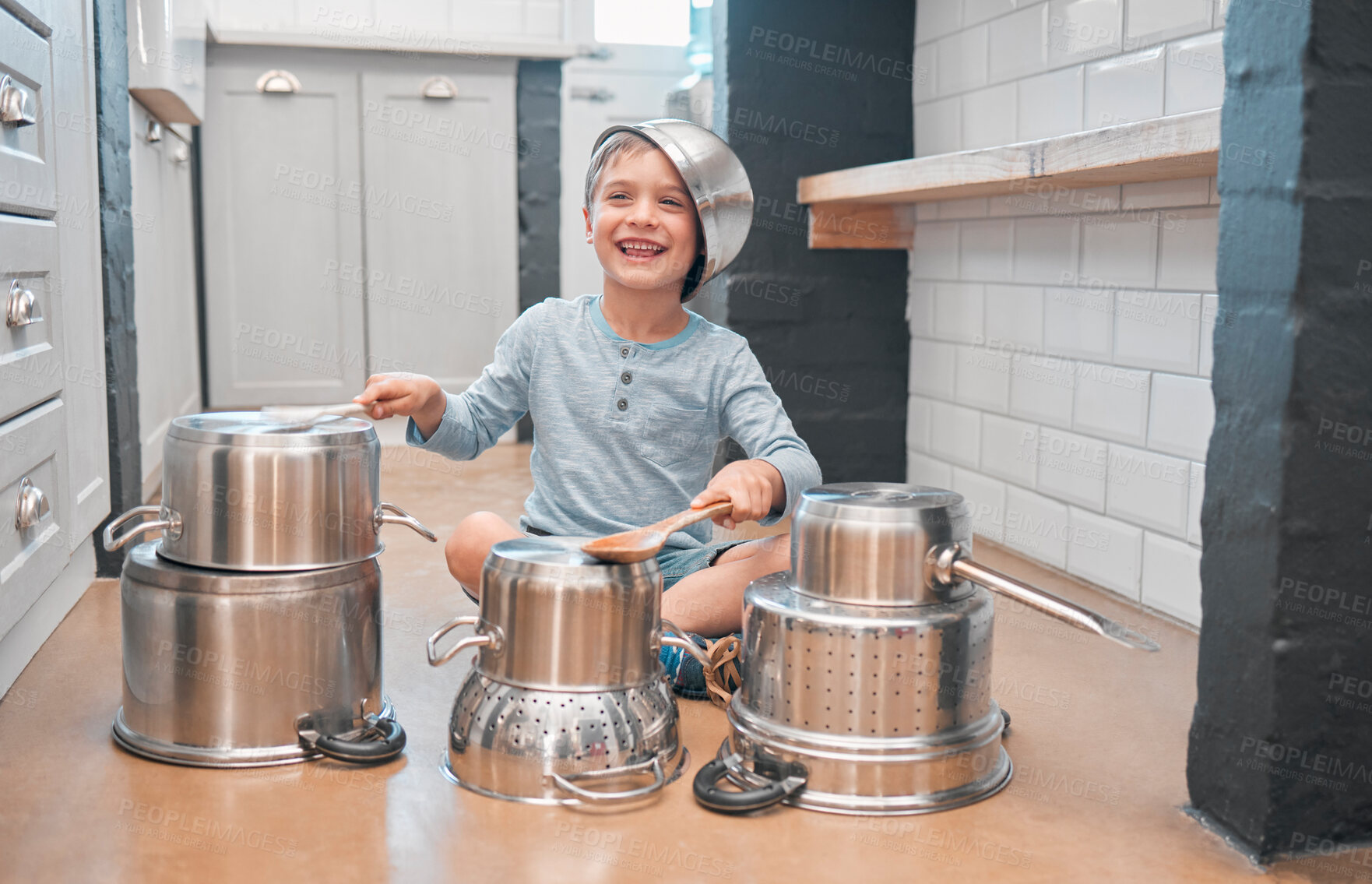 Buy stock photo Shot of an adorable little boy playing with pots in the kitchen
