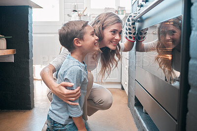 Buy stock photo Shot of a little boy and his mother sitting in front of the oven