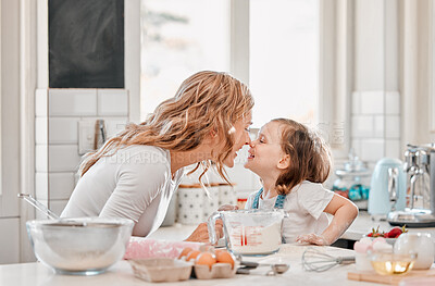 Buy stock photo Shot of a mother and daughter playing in the kitchen at home