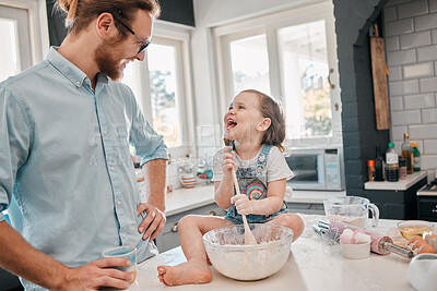 Buy stock photo Shot of a father and daughter banking at home in the kitchen