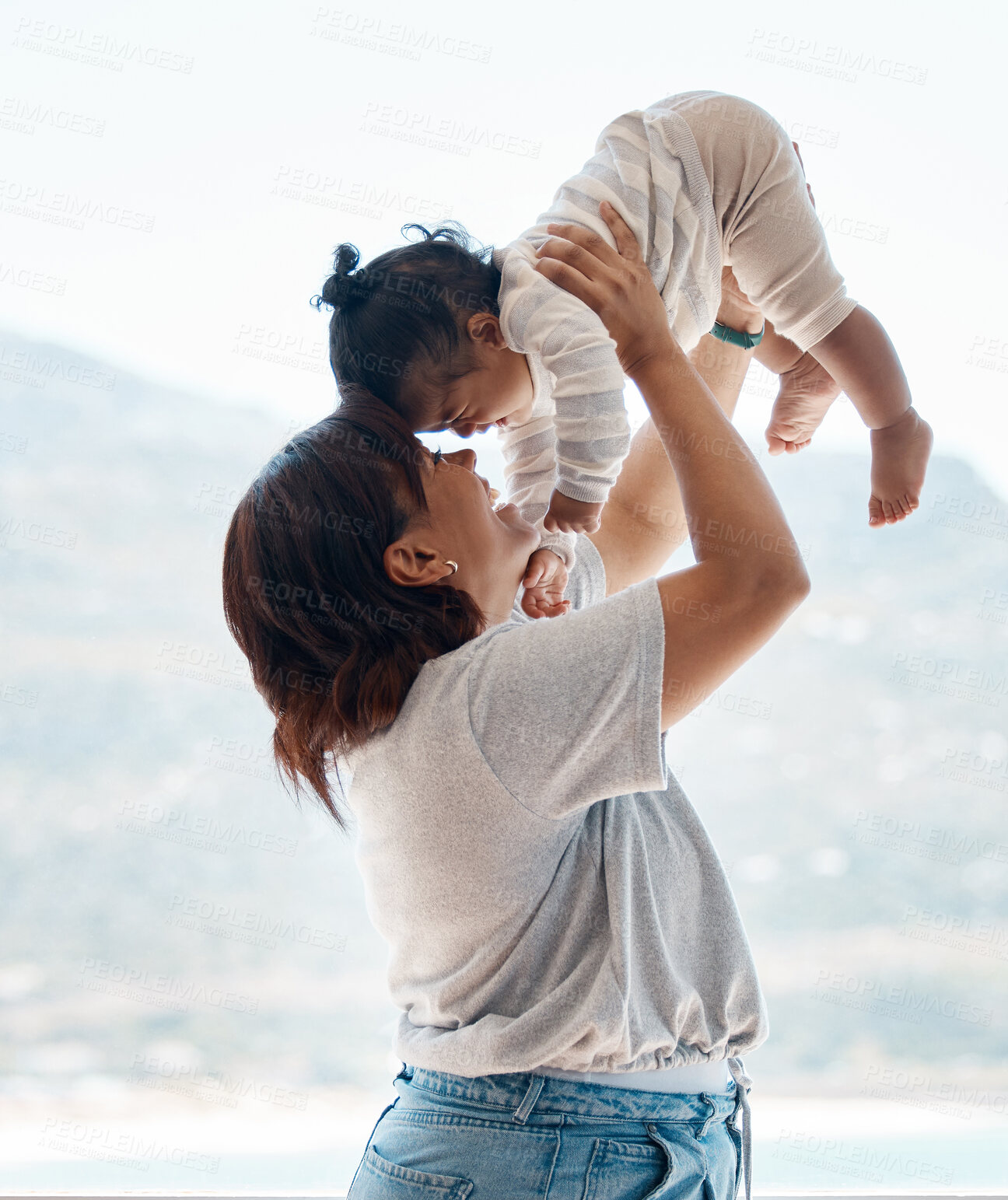 Buy stock photo Shot of a young woman playing with baby daughter