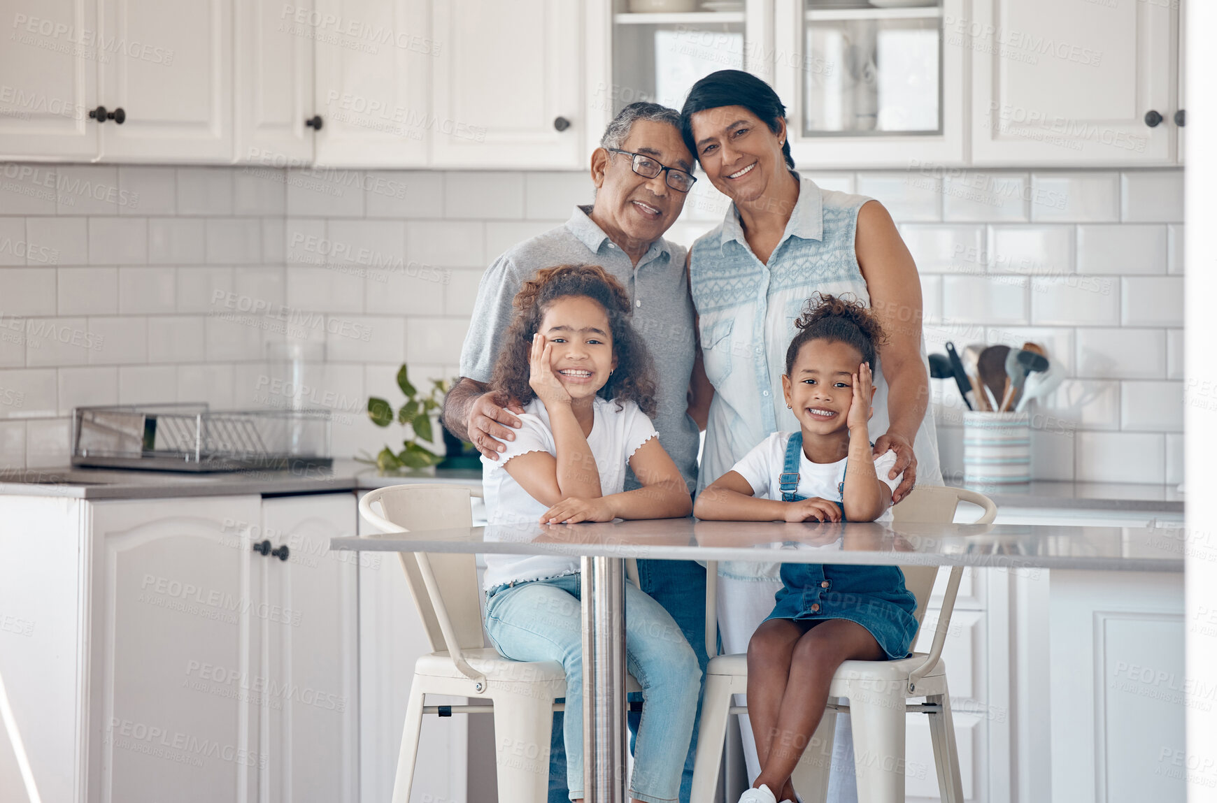 Buy stock photo Shot of grandparents spending time with their grandchildren