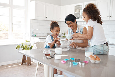 Buy stock photo Shot of a mature woman baking with her granddaughters