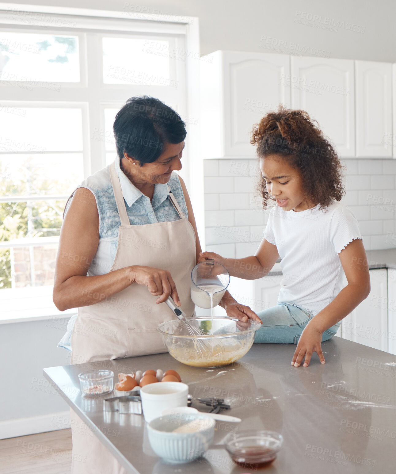 Buy stock photo Grandmother, girl and learning in kitchen for baking, development and bonding for motor skills. Child, mature woman and creative in home, teaching and growth with happiness, joy and cognitive ability